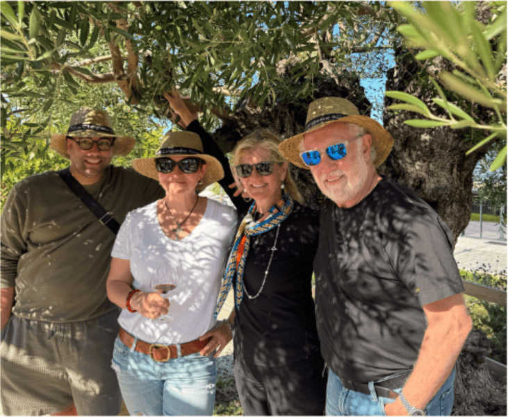 Group of friends enjoying wine outdoors at Princess & Bear Wines event.