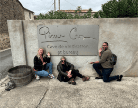 Group of three people at Princess & Bear Wines cave entrance, celebrating after-party.