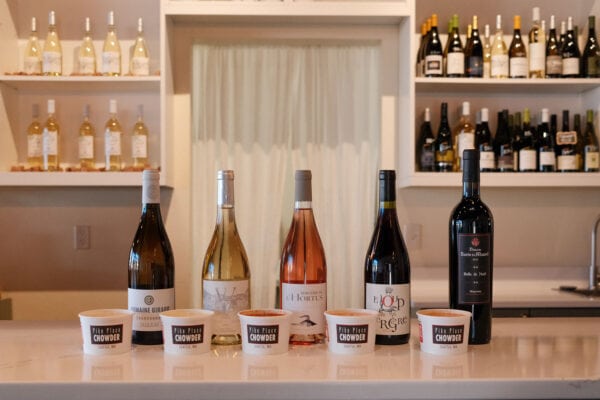 Princess & Bear Wines tasting flight with five different wine bottles on a bar counter.
