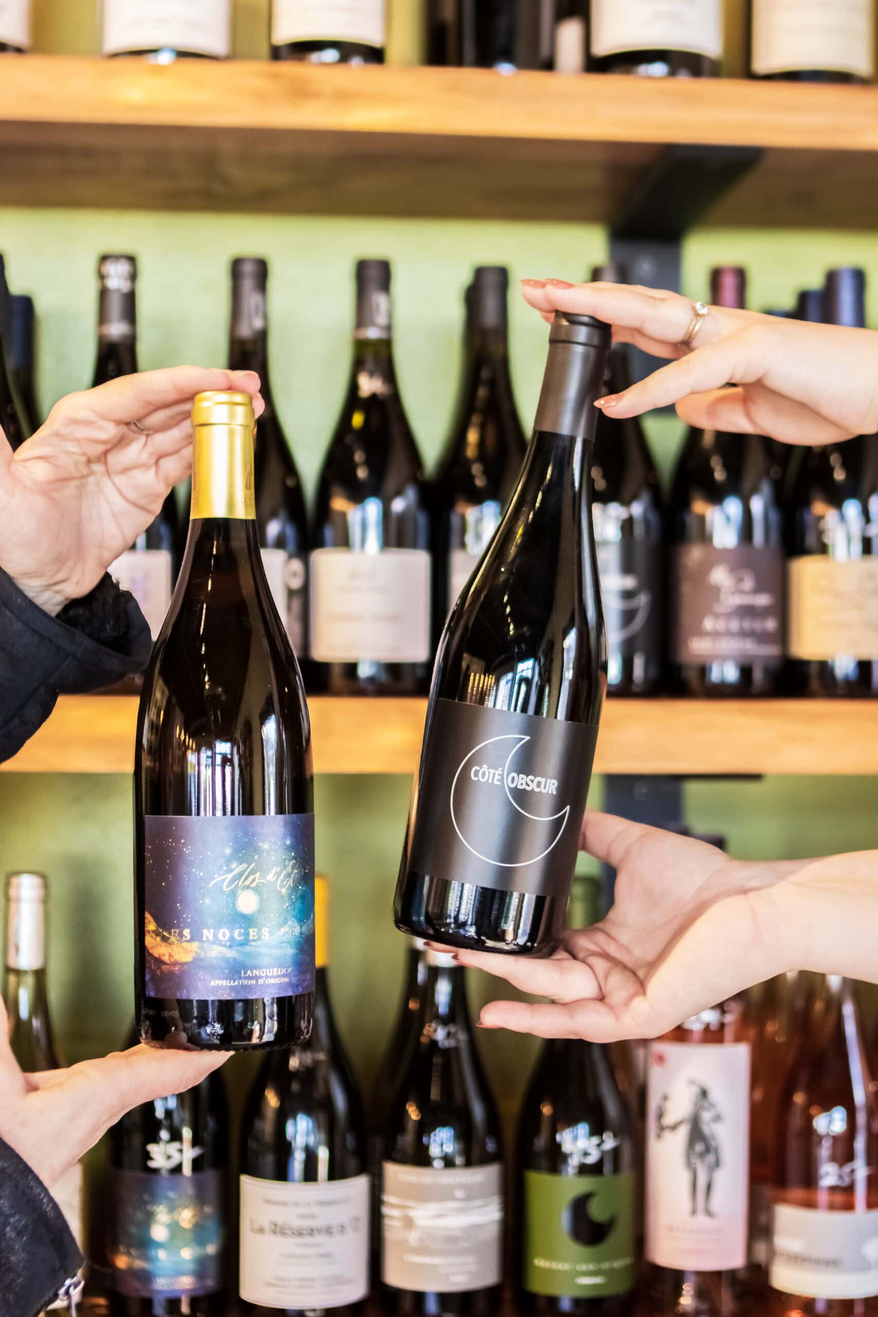 People selecting wine bottles from Princess & Bear Wines wine club collection.